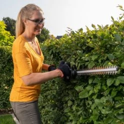 AL-KO HT 1845 18V Bosch Home & Garden Compatible Cordless Hedge Trimmer (Tool Only) -Garden Tool Store al ko ht1845 hedge trimmer lifestyle in use 2