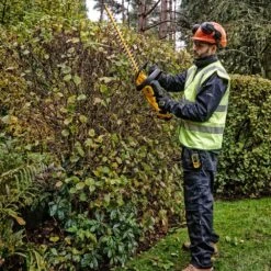 DeWalt DCMHT563P1-GB 18V XR Cordless Hedge Trimmer (with 5Ah Battery & Charger) -Garden Tool Store dewalt dcmht563 hedge trimmer lifestyle 4