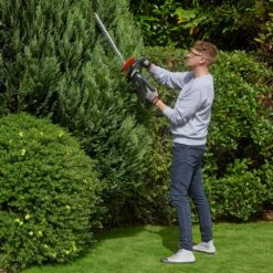 Flymo UltraCut 500 18V Cordless Hedge Trimmer (with 2.5Ah Battery & Charger) -Garden Tool Store flymo ultracut500 hedge trimmer lifestyle conifer