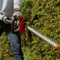 Flymo UltraCut 500 18V Cordless Hedge Trimmer (with 2.5Ah Battery & Charger) (Bundle Builder) -Garden Tool Store flymo ultracut500 hedge trimmer lifestyle in use 1