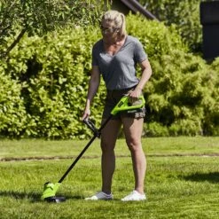 GreenWorks G24LT25K2 25cm 24V Cordless Grass Trimmer (with 2Ah Battery & 0.5A Economy Charger) -Garden Tool Store gwg24lt25 in use 1
